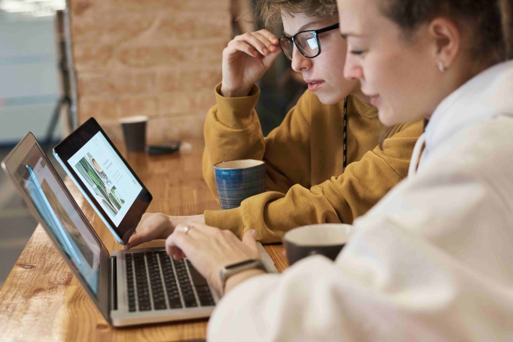 two women working on their laptops